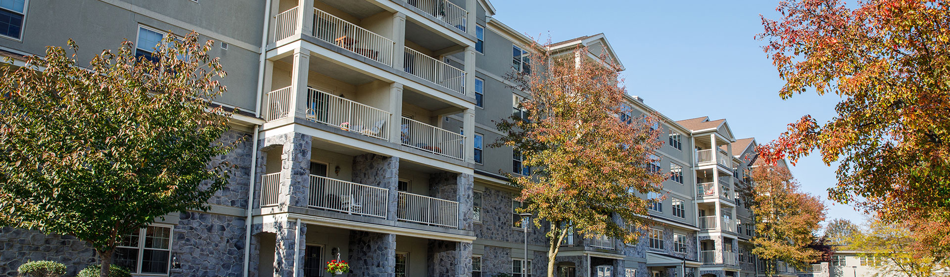 Apartments with balcony and trees in front of it